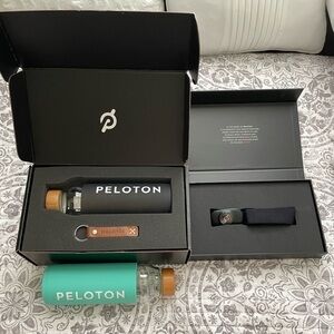 New Peloton set- two water bottles and a heart monitor and a key chain